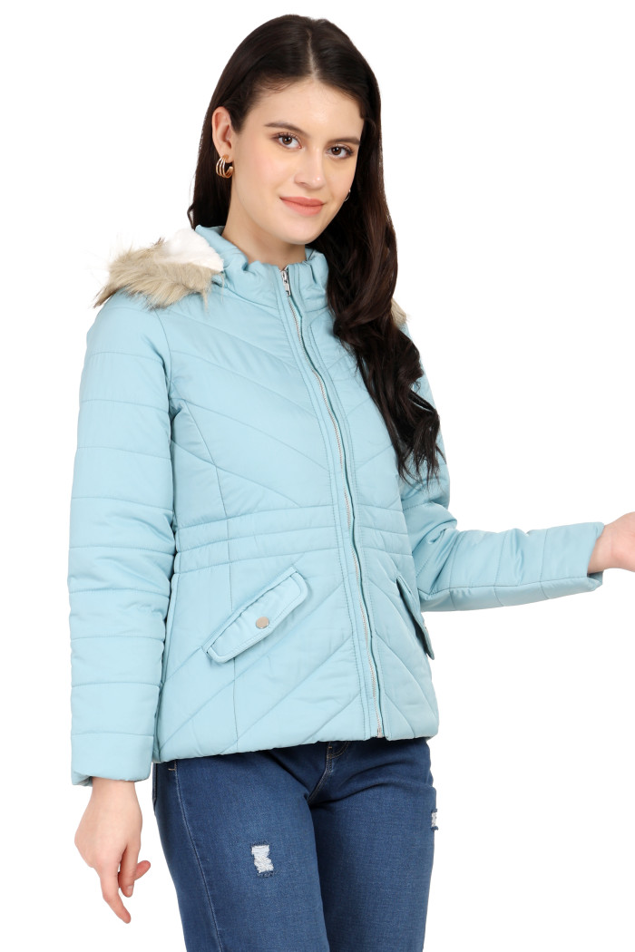 A standing pose of a woman wearing Coatsnmore’s casual jacket in Sea Green colour with a textured pattern, slash placket pockets, a zip closure, a detachable hood and blue jeans.